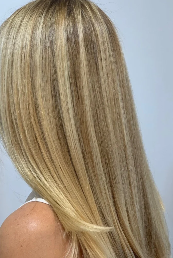 Long, straight blonde hair with fine hi-lites, seen from the side
